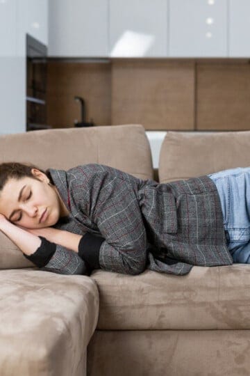 Woman napping on couch.