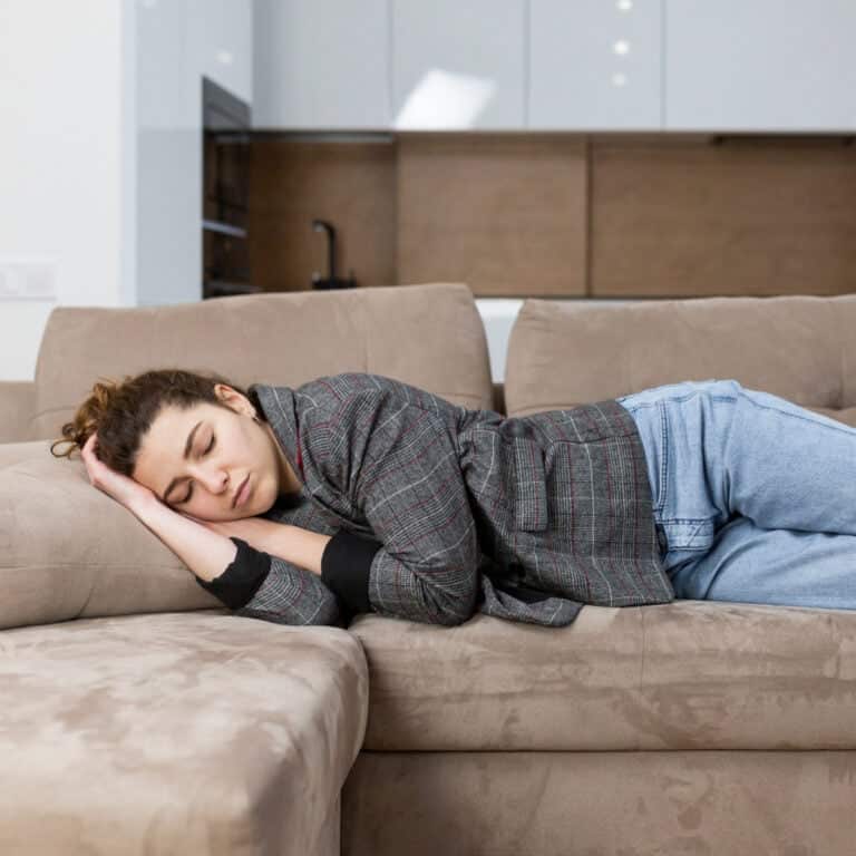 Woman napping on couch.