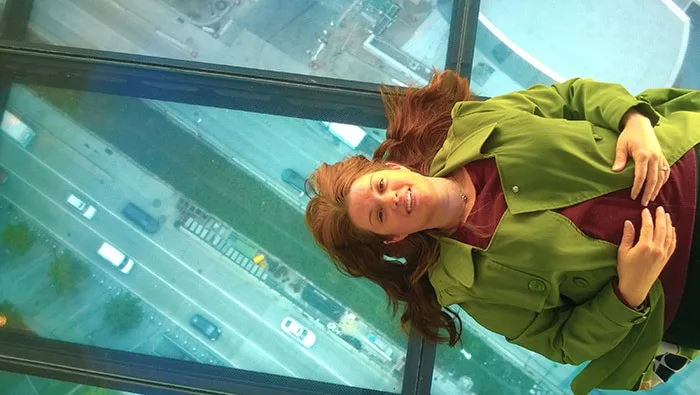 The new observatory at the World Trade Center is open for business, and the view is spectacular! The elevator ride is amazing as well. Here's what you can expect if you visit, including dining options and how to buy tickets. One World Observatory - Amy lying down on Sky Portal