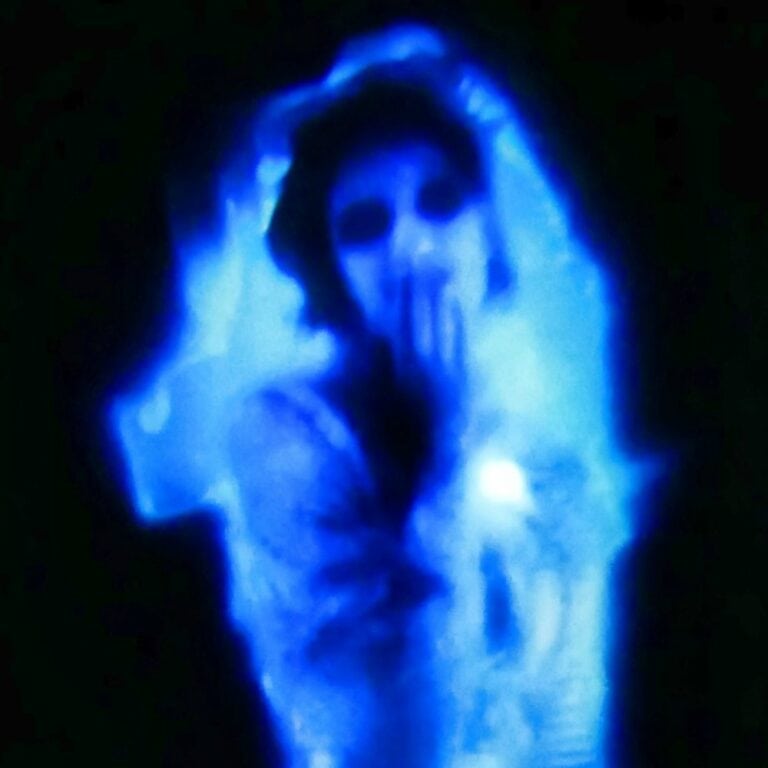 Looking for scary Halloween decorations that you can do from inside of your house? Read on for a really simple way to decorate with a window projector! It's the best of both worlds: you'll be entertaining the trick-or-treaters outdoors with creepy indoor decorations! #halloween #decorations #windowprojector