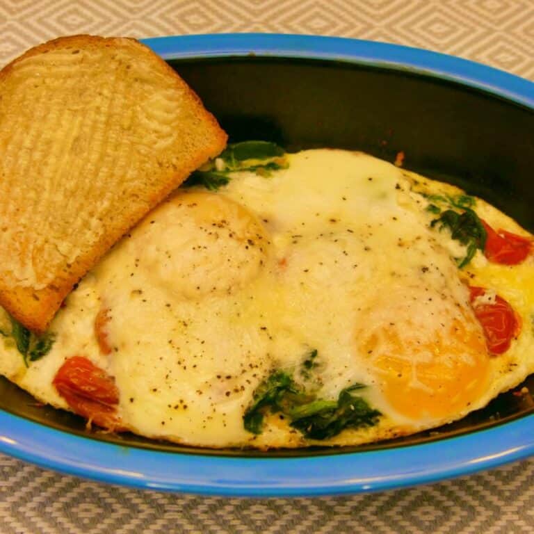 Looking for a breakfast or brunch dish that’s adaptable for everyone in your family? Try baked eggs with cream and vegetables! Baking eggs in the oven this way is easy, especially if you're trying to please people with different tastes, since each serving is baked up in its own dish. Personally, I like mine with tomatoes, spinach, and a little Parmesan, but you get to make it your own! #BakedEggs #Breakfast