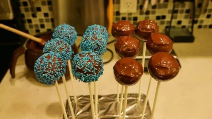 12 blue sprinkle and chocolate cake pops