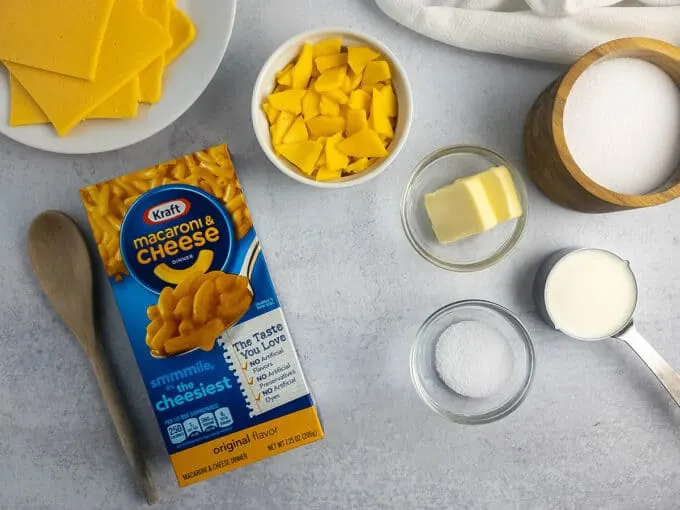Box of Kraft Macaroni & Cheese and additional ingredients, like sliced American cheese, butter, and milk.