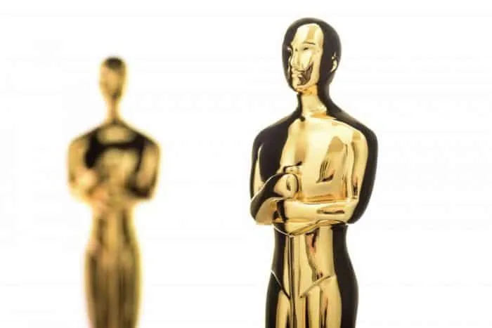 Two gold statues that are supposed to look like Oscar statues