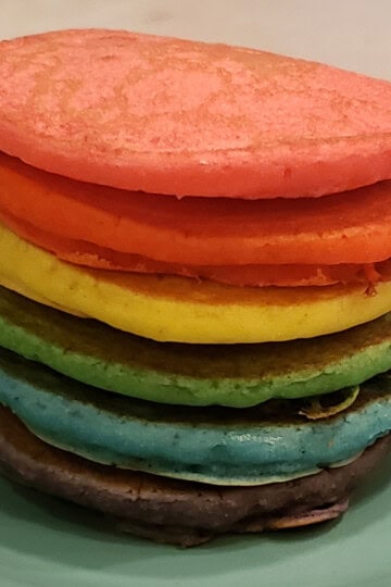 Rainbow pancakes are a fun breakfast idea for kids that you can make quickly and easily. I'll show you how to make these awesome pancakes in just a little more time than regular pancakes would take! #rainbows #pridemonth #rainbowpancakes #pridefood