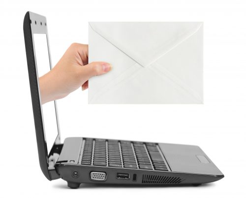 Envelope and hand coming out of a laptop screen