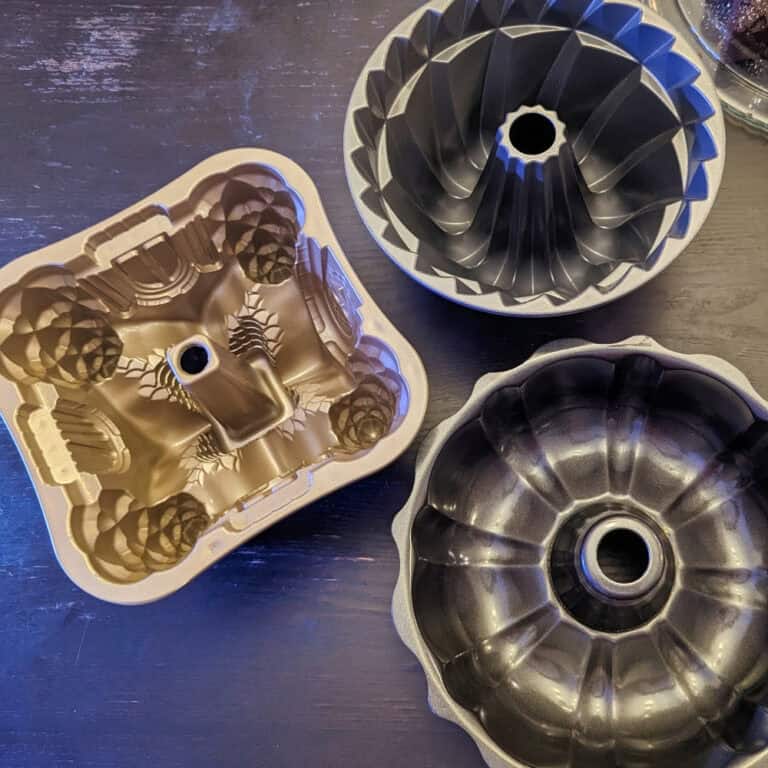 Three bundt pans with intricate designs.