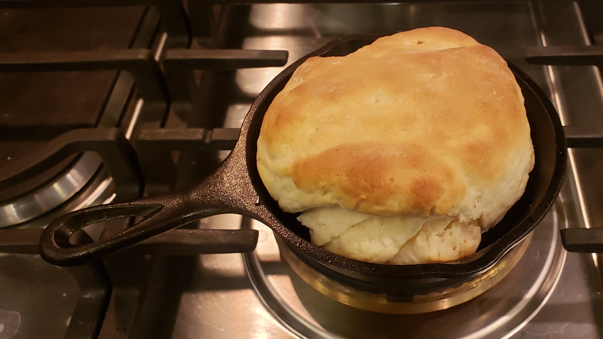 A large, ugly biscuit in a tiny cast-iron pan.