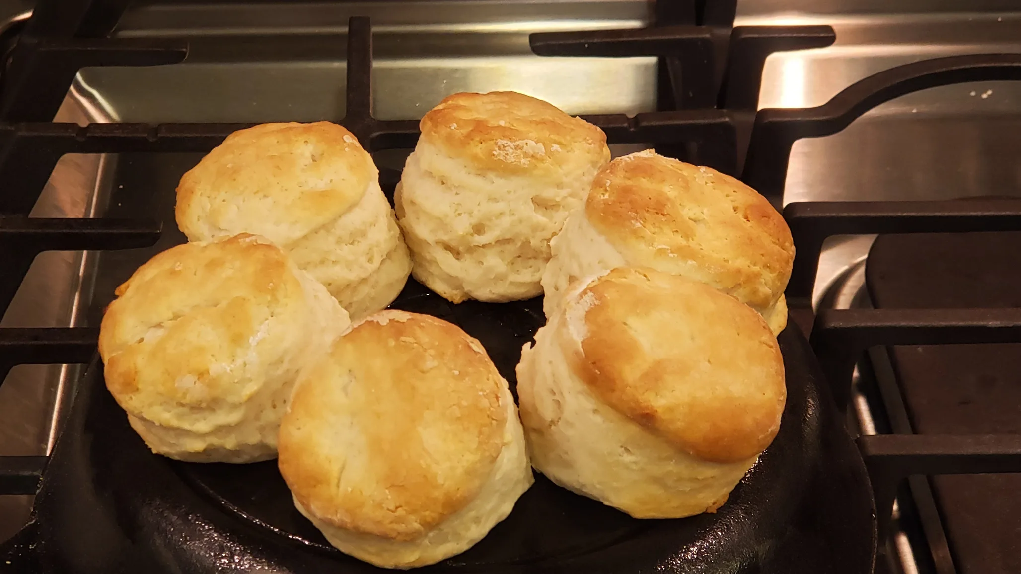 https://amyeverafter.com/wp-content/uploads/2023/04/lopsided-biscuits-on-back-of-cast-iron-pan.jpg.webp