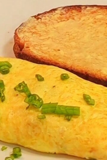 An easy folded omelet with toast on a plate.
