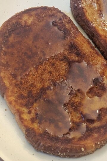 Close up of a slice of Cinnamon Toast Crunch French Toast on a plate.