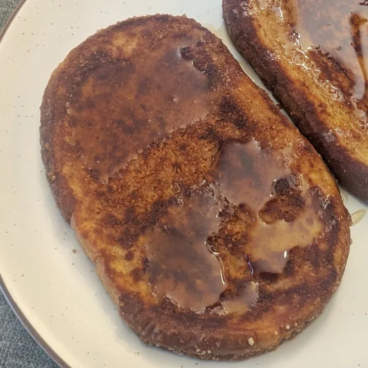 Close up of a slice of Cinnamon Toast Crunch French Toast on a plate.