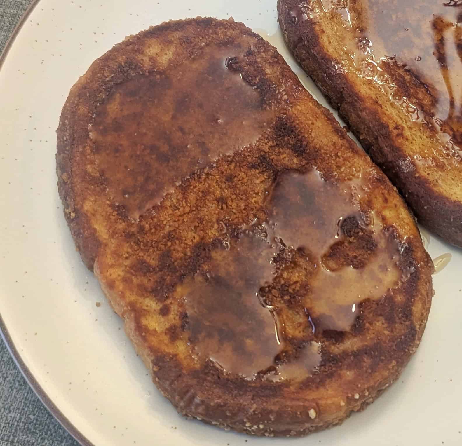 Close up of a slice of Cinnamon Toast Crunch French Toast on a plate.