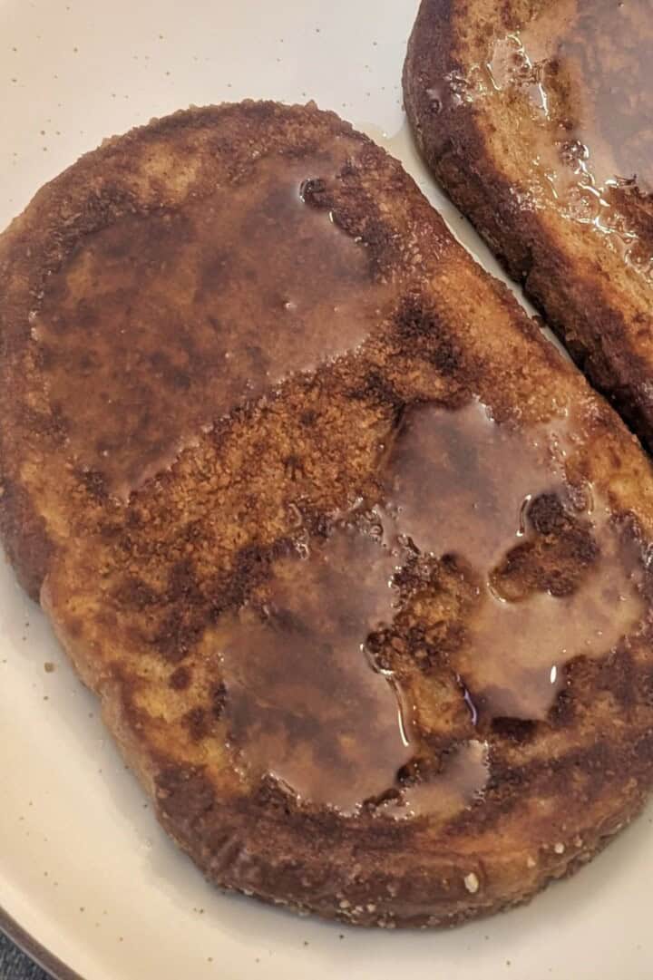 Cinnamon Toast Crunch French Toast on a plate, covered in syrup.