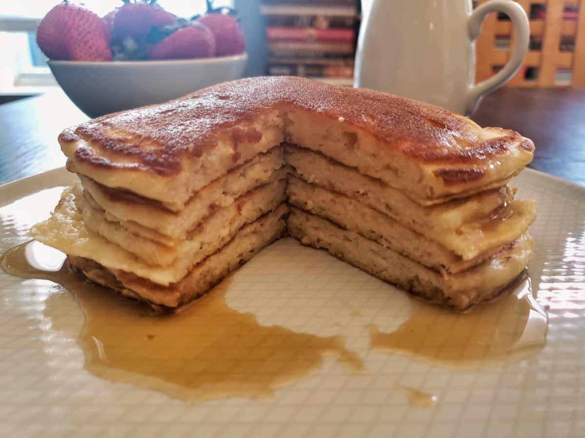 A stack of pancakes with syrup.